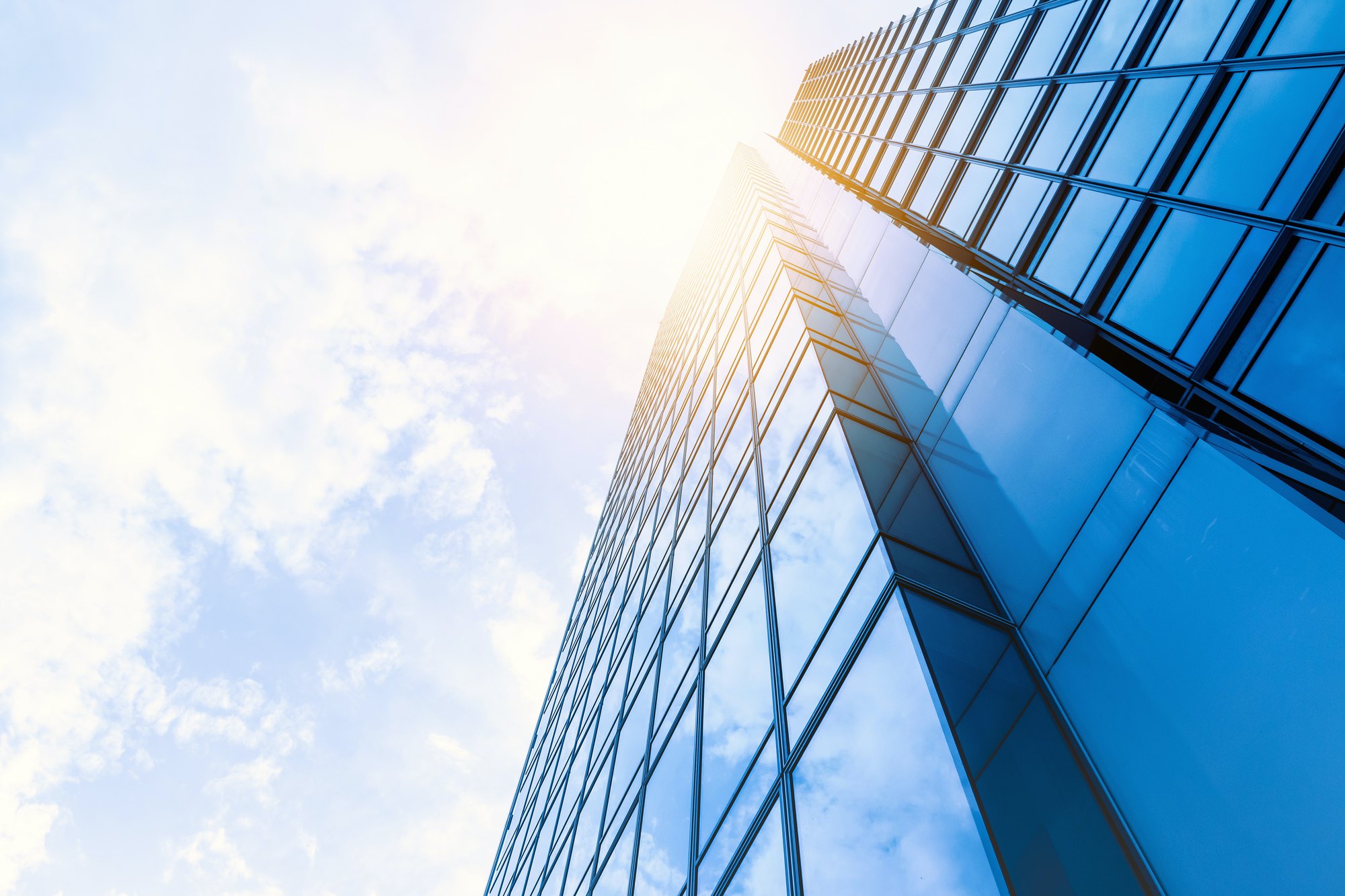 Sunlit glass facade of a modern office tower